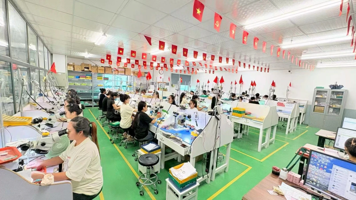 Company-supplied photograph of precision jewelry workstations inside JINYI's Vietnam manufacturing facility.