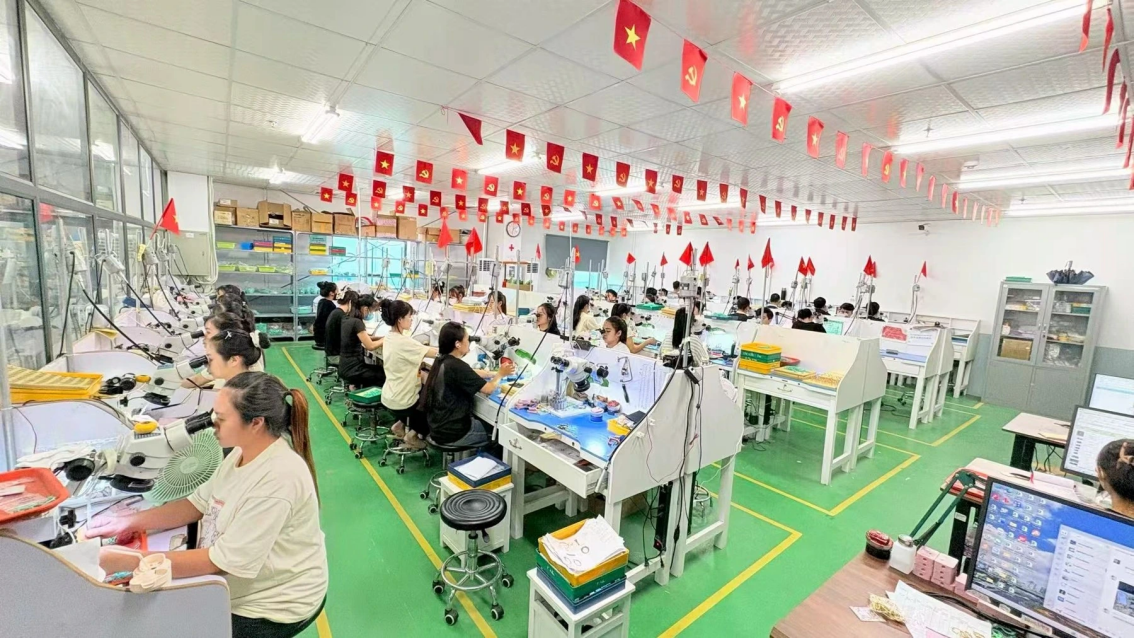 Company-supplied photograph of precision jewelry workstations inside JINYI's Vietnam manufacturing facility.