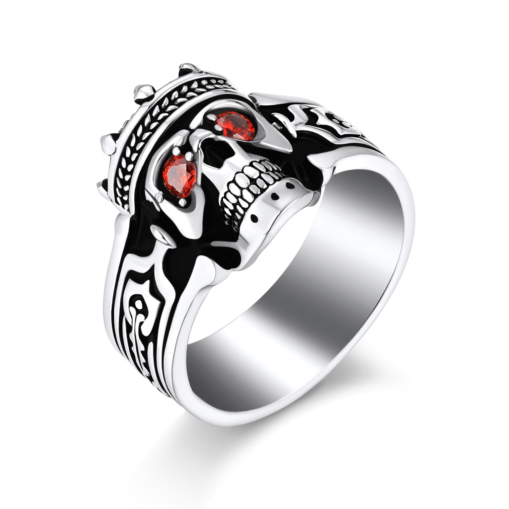 Dark skull king ring with crown and fiery red gemstone eyes.